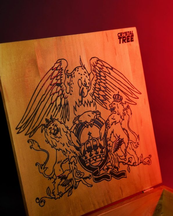 Laser-engraved crest cut into a wooden lid